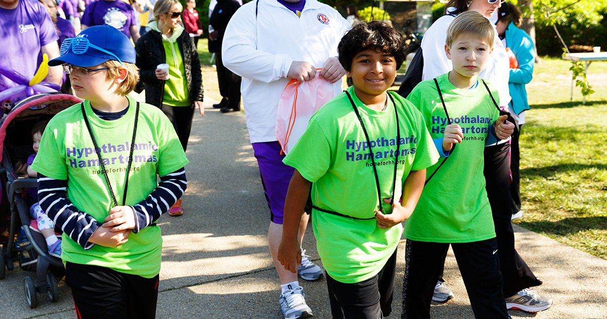 children walking to fundraise for gelastic and dacrystic seizures wearing hypothalamic hamartomas shirts